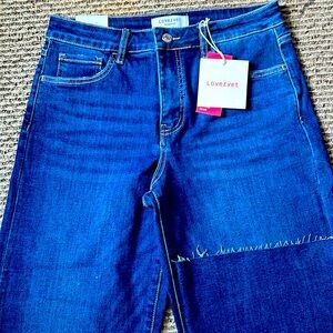 Jeans, wide leg cropped, no distressing. Dark blue denim, frayed hemline